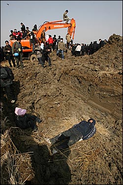 15일 오전 주민들이 포크레인이 파 놓은 구덩이에 들어가서 농성을 벌이고 있다. 